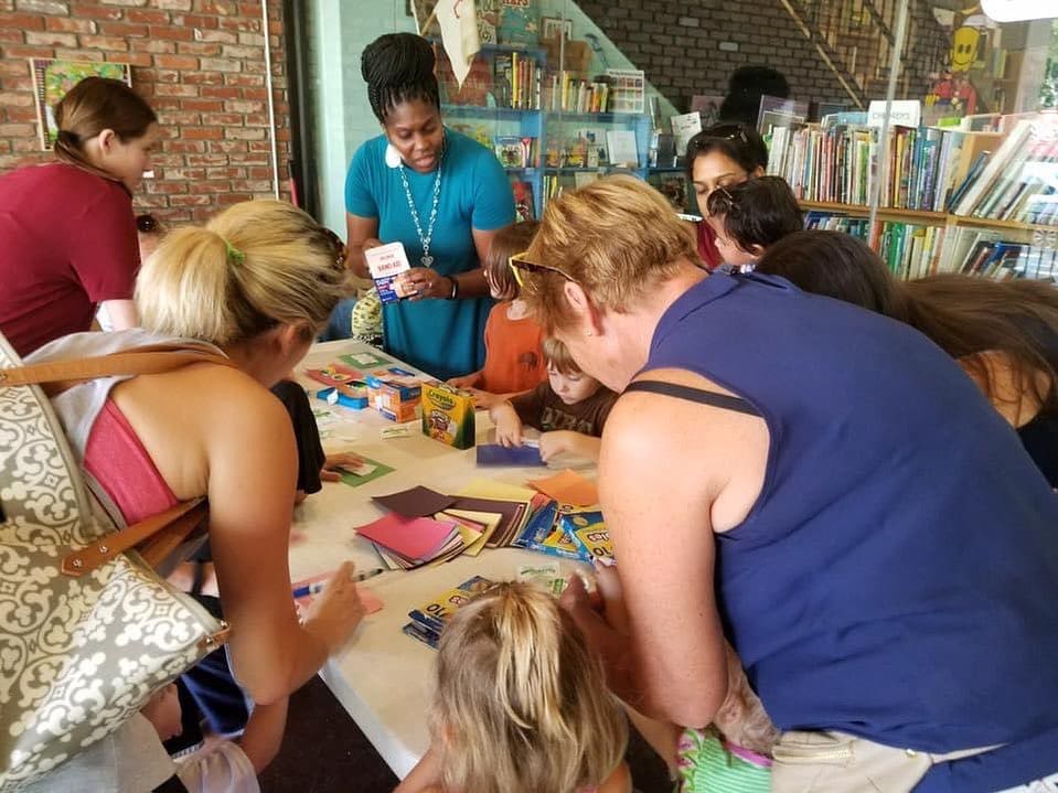 a group of people at a table coloring