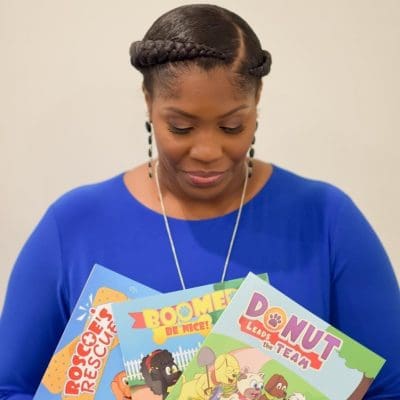 A picture of Stacy, owner of SMR, holding books.